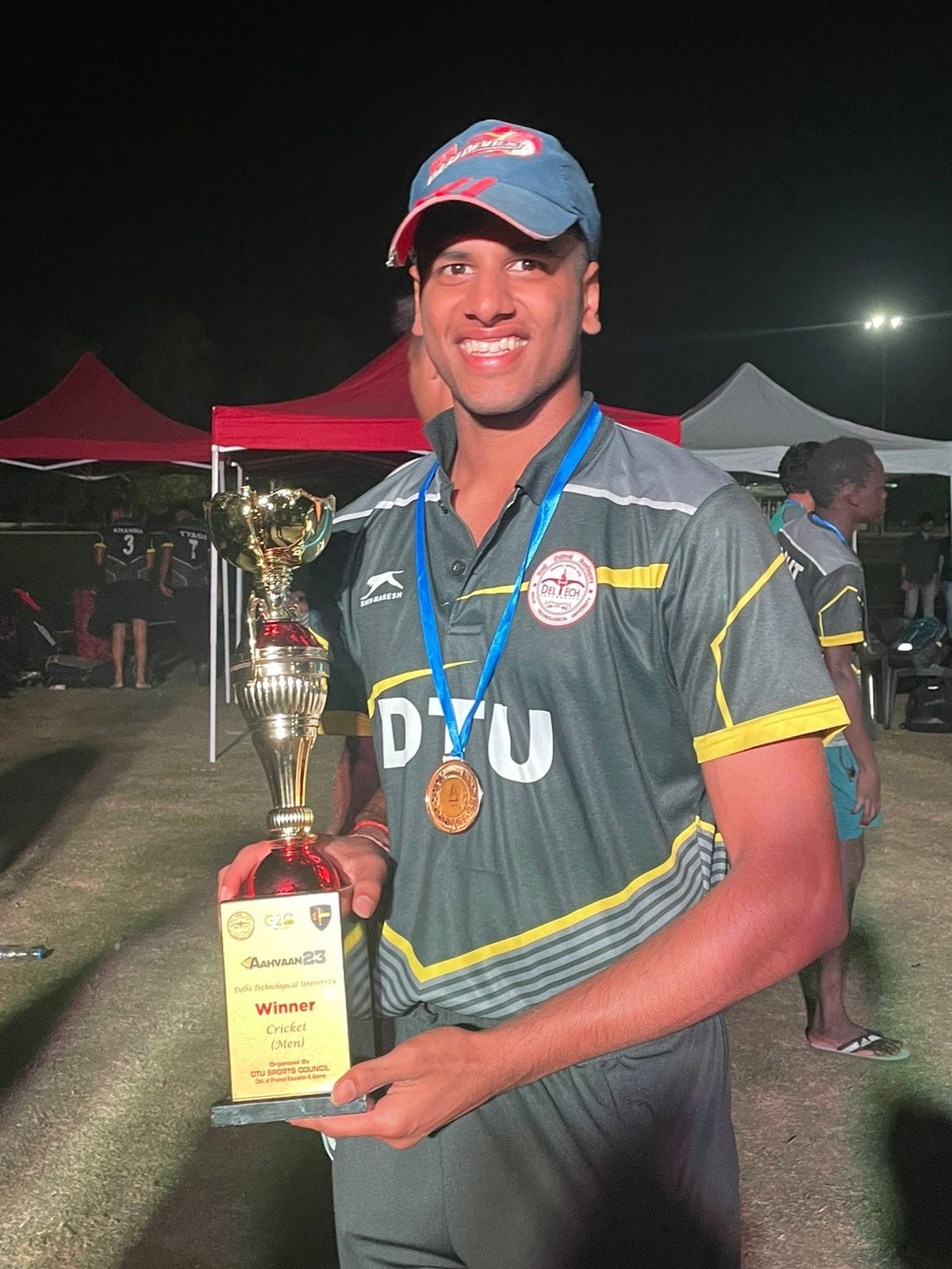 Ribhav holding the AAHVAAN 23 DTU cricket winners trophy