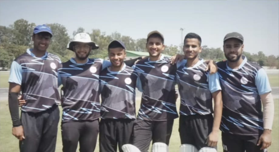 Ribhav with his cricket teammates in kit on the ground
