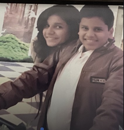 Ribhav at his heaviest, standing with his sister