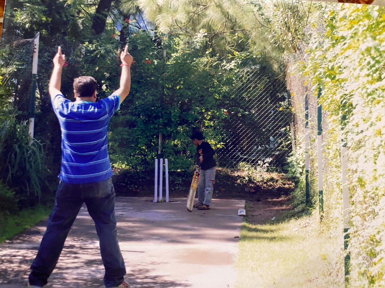 A young Ribhav batting on a backyard pitch
